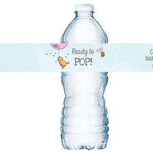 May include: A blue and white water bottle label with a Winnie the Pooh character holding a pink balloon. The label reads "Ready to POP!" and "Cynthia's Baby Shower June 17, 2016".