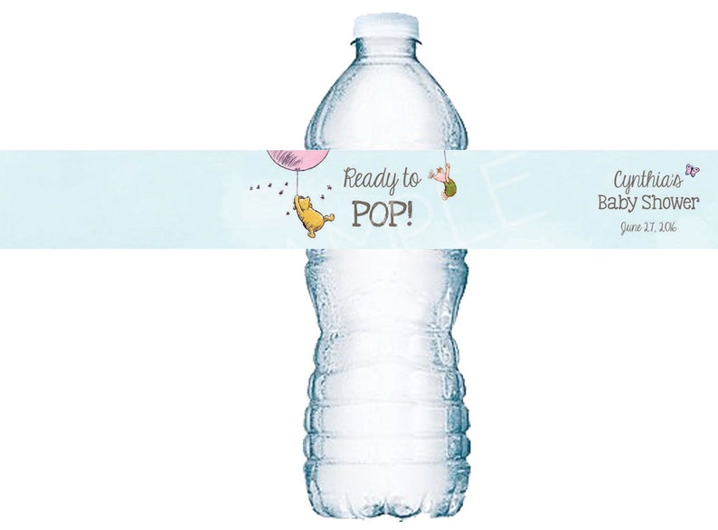 May include: A blue and white water bottle label with a Winnie the Pooh character holding a pink balloon. The label reads "Ready to POP!" and "Cynthia's Baby Shower June 17, 2016".