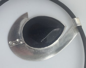 Sand stone sparkling pendant on black rubber choker wrapped with silk thread.