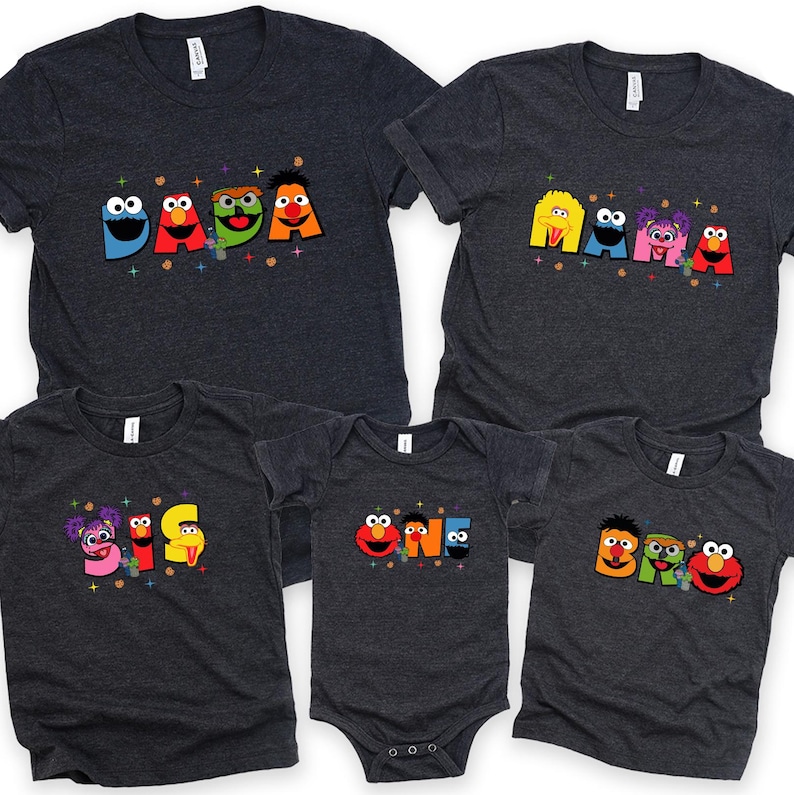 a collection of five gray t-shirts with colorful characters and text printed on them.