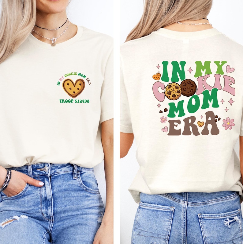 A woman wearing a white t-shirt with a graphic design on the back, featuring a cookie and the text "In my cookie mom era" along with other cookie-related imagery.