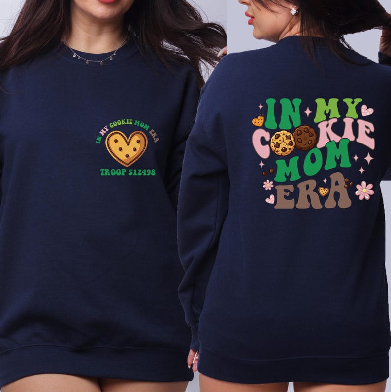A woman wearing a navy blue sweatshirt with a graphic design on the back.