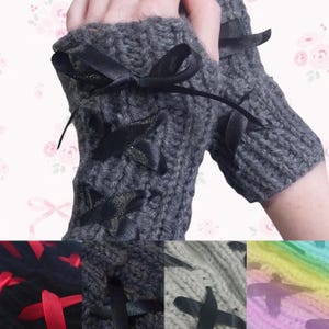 May include: Grey knitted fingerless gloves with black ribbon bows and lace-up details. The gloves are shown in different colours, including black, grey, and a rainbow gradient.