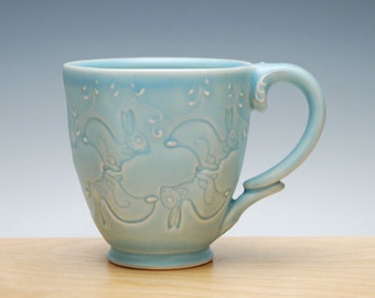 Hopping Bunnies mug in Frost