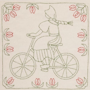 May include: A green embroidered design of a person riding a bicycle with tulips around the border.