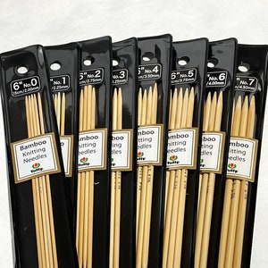 May include: A set of seven pairs of 6-inch bamboo knitting needles in individual plastic packaging. The needles are labeled with their size in inches and millimeters. The packaging is black with white text and a tulip logo.