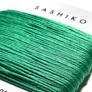 May include: A spool of green Sashiko thread, 100% cotton, 30 meters long.