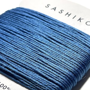 May include: A spool of blue cotton thread for sashiko embroidery. The label reads "Sashiko" and "100% Cotton" and "30m".