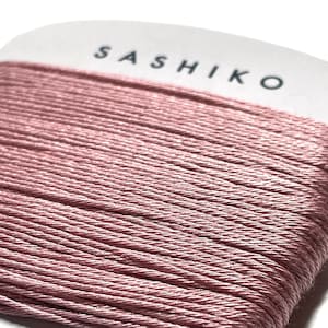 May include: A spool of pink Sashiko thread, 100% cotton, 30 meters long.