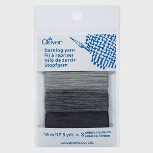 May include: A package of Clover darning yarn in a gradient of gray shades. The package includes three colors of yarn, each 17.5 yards (16 m) long. The package has text in English, French, Spanish, and German.
