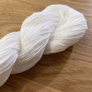 May include: A skein of white cotton yarn, perfect for knitting or crocheting.