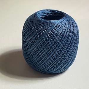 May include: A ball of blue yarn, ready for knitting or crocheting.