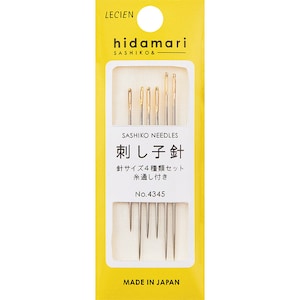 May include: A package of sashiko needles with gold-colored eyes and silver shafts. The package is yellow with Japanese text and the words "Sashiko Needles" and "Made in Japan". The needles are for hand sewing and embroidery.