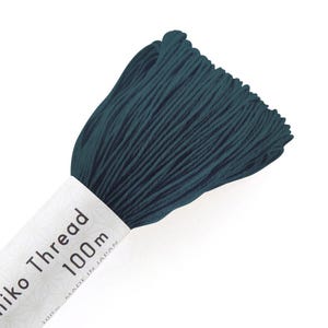May include: A spool of dark teal embroidery thread with a white label that reads "Sashiko Thread 1000m Made in Japan".