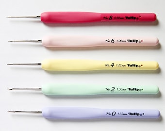 May include: Five crochet hooks in different colors and sizes, labeled with their size in millimeters. The hooks are labeled "No. 8 0.90mm Tulip", "No. 6 1.00mm Tulip", "No. 4 1.25mm Tulip", "No. 2 1.50mm Tulip", and "No. 0 1.75mm Tulip".