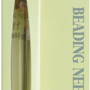 May include: A package of Tulip beading needles, size #11, containing 4 pieces. The package is light green with the words "Tulip Beading Needles" in black. The needles are visible through a clear window.