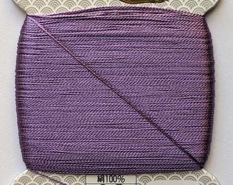 May include: A spool of purple silk thread with a white label that reads "Made in Japan" and "217". The label also includes the text "Silk 100%, 9号, 23dtex×9×2(s), 80m巻, 普通染".