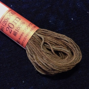 May include: A brown skein of 100% cotton thread, labeled #6 (20s x 6) 20m. The label also includes the text "株式会社ブック" and an address in Japanese.