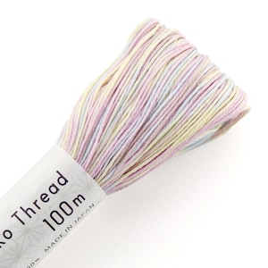 May include: A skein of pale pink, light blue, and cream colored embroidery floss. The floss is wound around a white label that reads "Ko Thread 1000m Made in Japan".