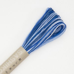 May include: A spool of blue, white, and light blue embroidery floss with the text "Sashiko" and "刺し子" in Japanese on the label.