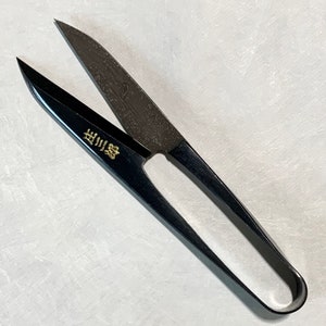 May include: Black fabric shears with a gold inscription that reads "出刃物".