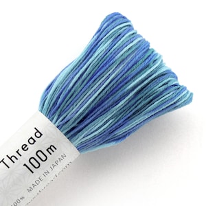 May include: A skein of blue and green embroidery thread, labeled "Thread 100m" and "Made in Japan".