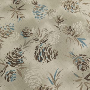 May include: A fabric with a repeating pattern of pine cones and foliage in shades of brown, blue, and white on a beige background. The design features detailed illustrations of pine cones and leaves, creating a natural, textured look.