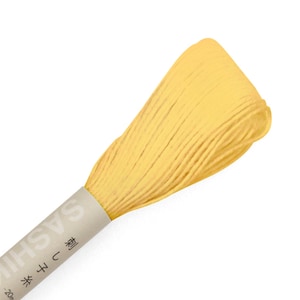 May include: A spool of yellow embroidery floss with the text "Sashiko" and "型" in Japanese characters on the label.
