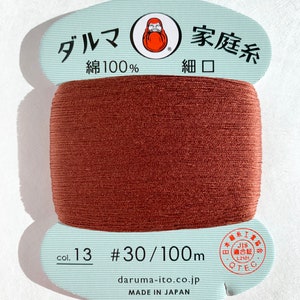 May include: A spool of brown cotton thread labeled "Daruma Family Thread, 100% Cotton, Fine Mouth, Col. 13 #30/100m, daruma-ito.co.jp, Made in Japan". The spool has a JIS certification label.
