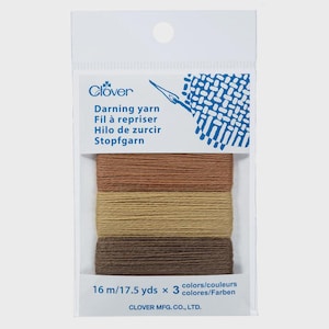 Peut inclure: Un paquet de fil à repriser Clover, contenant trois couleurs de marron : clair, beige et foncé. Chaque couleur contient 16 m de fil. L'emballage porte les mentions "Fil à repriser" et "Clover".