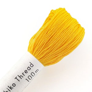May include: A spool of bright yellow embroidery thread with a white label that reads "Hiko Thread 100m".
