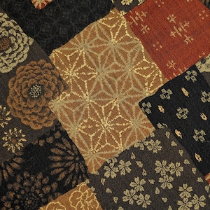May include: A patchwork fabric featuring a variety of patterns in shades of brown, gold, and red. The fabric includes floral, geometric, and abstract designs.