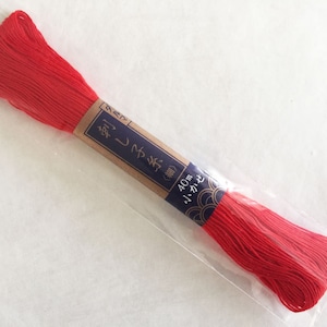 May include: A red spool of embroidery floss in a clear plastic bag with a brown label that says "40m" and has Japanese characters.