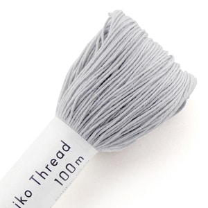 May include: A skein of light gray embroidery thread, labeled "Sashiko Thread 100m Made in Japan".