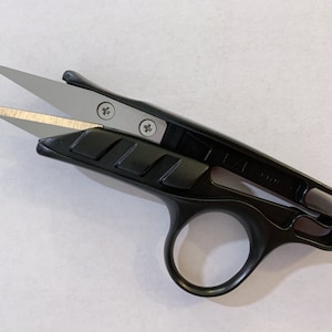 May include: Black thread snips with silver blades. The scissors have a finger loop and a textured handle for a secure grip. The blades are held together with small silver screws. Ideal for cutting threads and small fabrics.