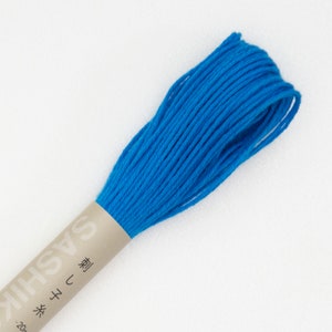May include: A spool of bright blue embroidery floss with a label that reads "Sashiko" in Japanese characters and "型" which means "pattern".