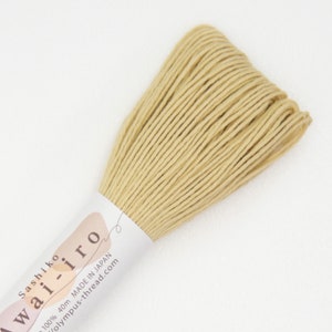 May include: A skein of pale yellow sashiko thread, labeled "Sashiko wai-iro 100% 40m Made in Japan olympus-thread.com"