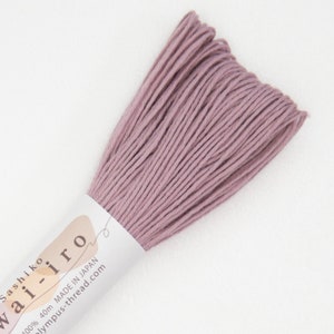 May include: A skein of dusty rose colored sashiko thread, labeled "Wairo Sashiko 100% 40m MADE IN JAPAN olympus-thread.com"