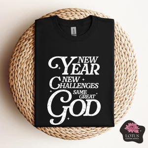 May include: Black t-shirt with white text that reads "New Year New Challenges Same Great God".
