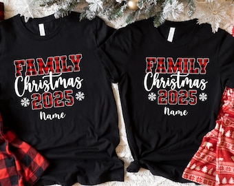 May include: Two black t-shirts with the text "FAMILY Christmas *2025* Name" in white and red plaid lettering. The shirts are decorated with snowflake designs and are perfect for a family Christmas celebration.