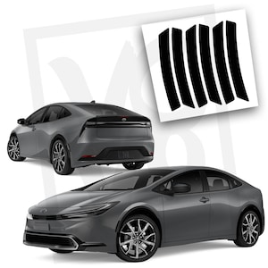 May include: A gray Toyota Prius in two views, front and rear, with a set of black vinyl trim pieces. The car has black wheels and a sleek, modern design. The trim pieces are curved and appear to be for the car's exterior.