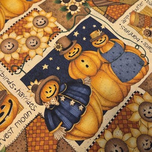 May include: Fabric featuring a patchwork pattern of smiling pumpkin figures wearing hats and blue clothing, sunflowers with jack-o'-lantern faces, and text including "harvest moon," "apple butter," "bonfires," and "hayrides" on a cream background.