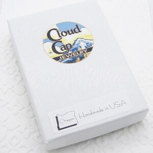 May include: White gift box with a blue and yellow logo that says "Cloud Cap Jewelry" and a sticker that says "Oregon" and "Handmade in USA".