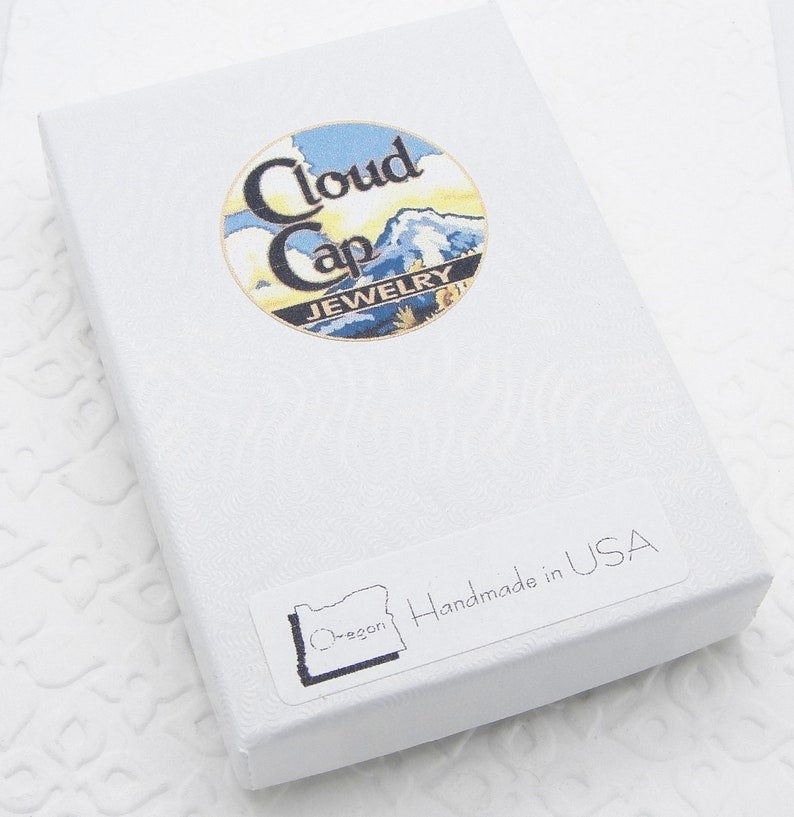 May include: White gift box with a blue and yellow logo that says "Cloud Cap Jewelry" and a sticker that says "Oregon" and "Handmade in USA".