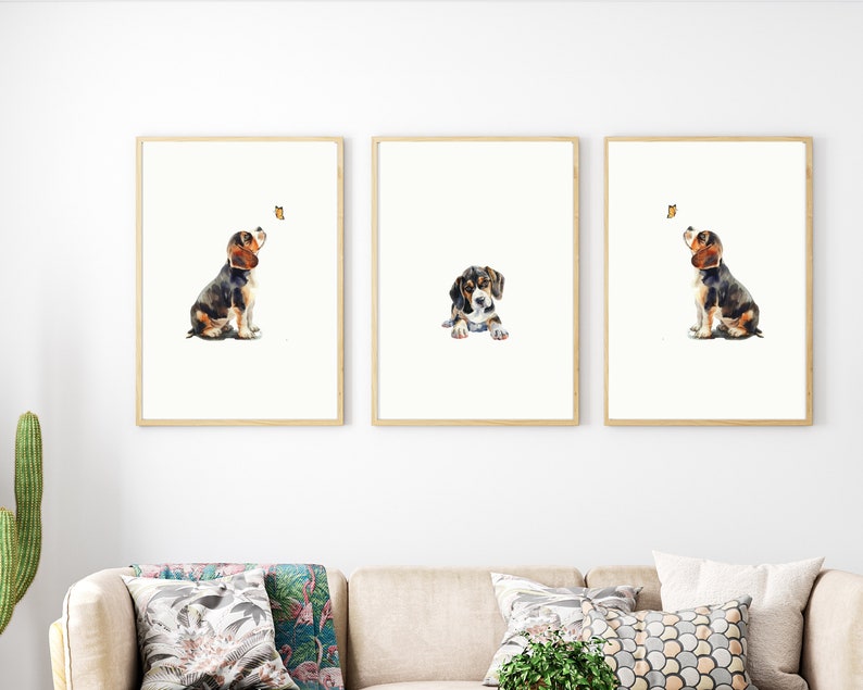 May include: Three framed watercolour paintings of a beagle puppy. Each painting features the puppy in a different pose, looking up at a butterfly.