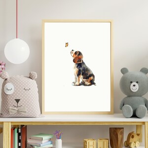 May include: A watercolour painting of a beagle puppy looking up at a butterfly. The puppy is brown, black, and white and is sitting on a white background.