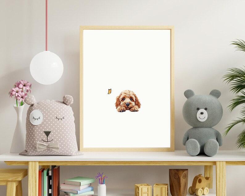 May include: A framed print of a brown and white puppy dog with a butterfly in the background. The print is hanging on a white wall above a wooden shelf with a stuffed animal and books.