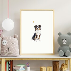 May include: A framed print of a black and white Australian Shepherd dog sitting and looking to the right. A small orange butterfly is flying above the dog.