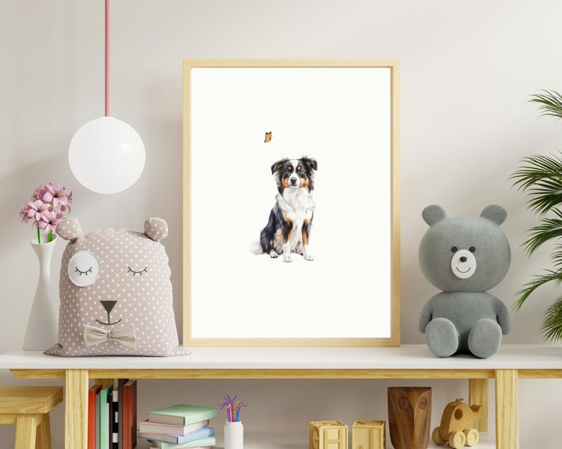May include: A framed print of a black and white Australian Shepherd dog sitting and looking to the right. A small orange butterfly is flying above the dog.