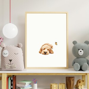 May include: A framed print of a golden doodle dog sleeping with a butterfly flying above it. The print is on a shelf with a stuffed animal bear, books, and other decorative items.